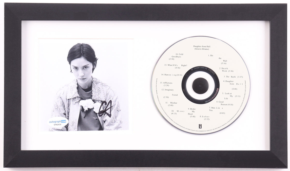Gracie Abrams signed Daughter from Hell framed CD display: black and white portrait photo signed in black marker with her GA initials, ACOA label on the lower left, beside the white album disc in a white mat and black frame