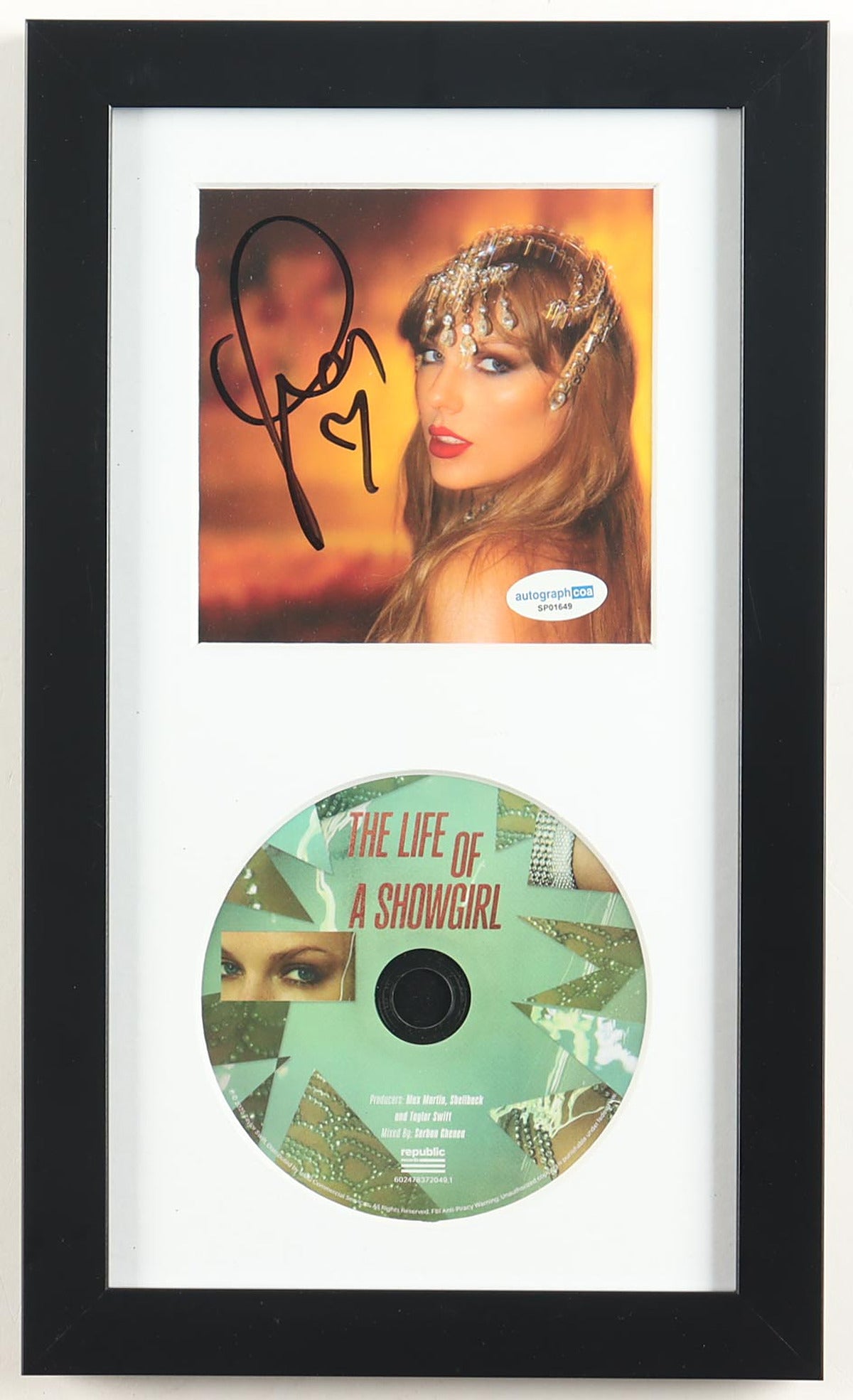 Taylor Swift signed The Life of a Showgirl framed CD display, the showgirl portrait insert signed in black marker with a hand-drawn heart and the ACOA label, above the mint green album disc in a black frame with white mat