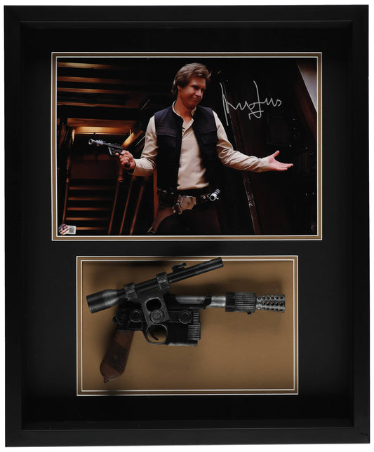 Harrison Ford signed Han Solo photo in a black shadowbox above a DL-44 blaster replica, Beckett Witnessed