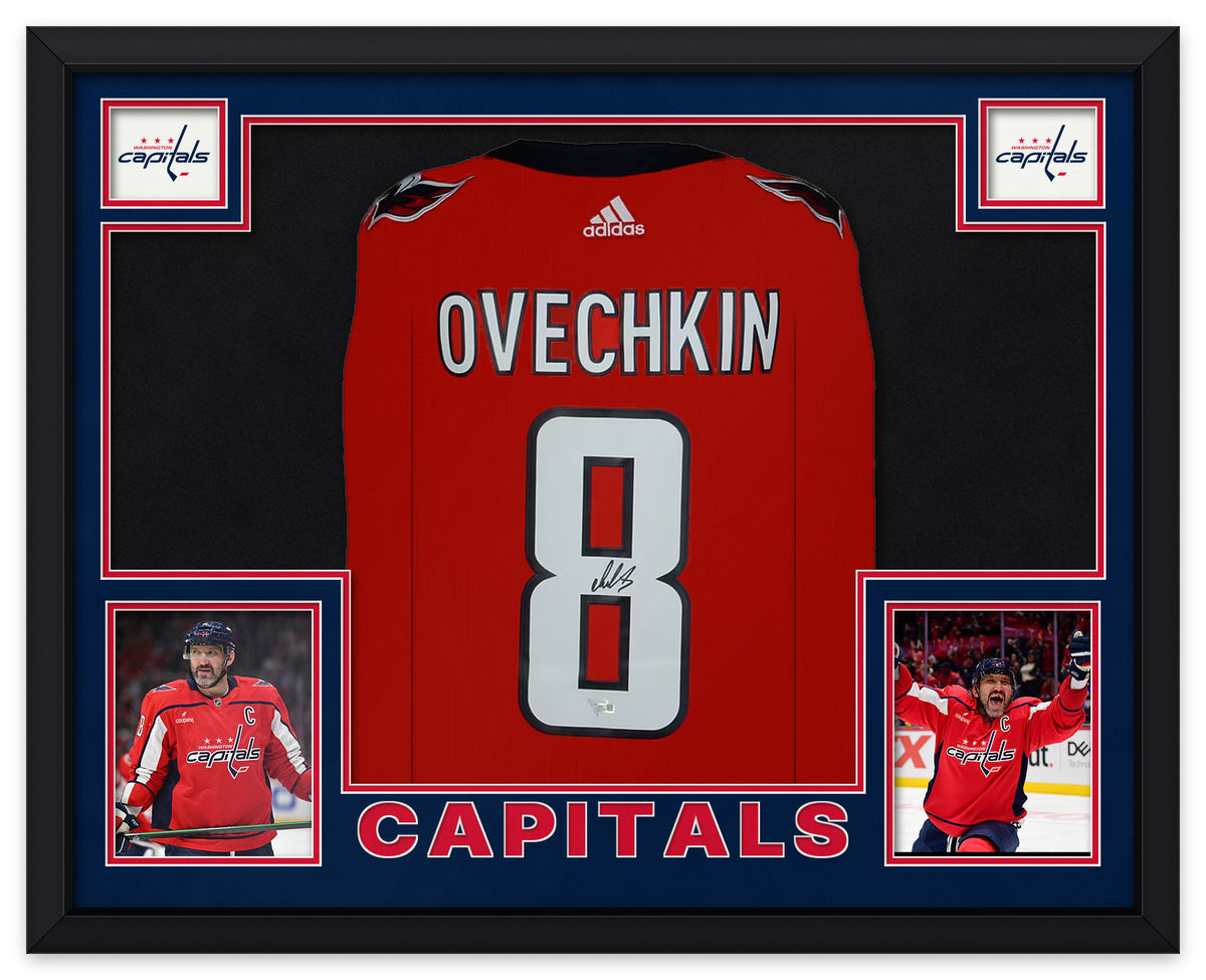 Alex Ovechkin signed red Washington Capitals number 8 jersey laid flat in a black frame with navy and red matting, Capitals logos, two photos of Ovechkin and CAPITALS lettering