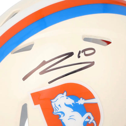 Close-up of the Bo Nix signature and number 10 in black marker above the Broncos D logo on the cream Riddell Retro mini helmet shell