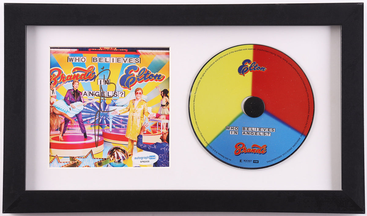 Brandi Carlile signed Who Believes in Angels? framed CD display: colorful album cover insert signed in black marker with the ACOA label, beside the yellow, red and blue album disc in a white mat and black frame