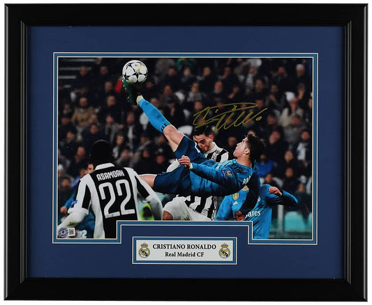 Cristiano Ronaldo signed 16x20 photo of his overhead bicycle kick for Real Madrid against Juventus, with a Beckett hologram on the photo, in a black frame with blue matting and a Real Madrid nameplate