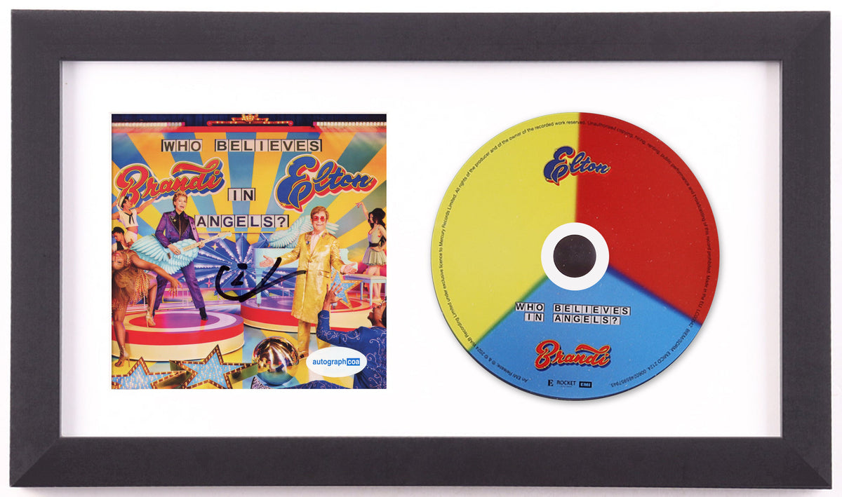 Elton John signed Who Believes in Angels? CD insert, signed in black marker, framed beside the yellow, red and blue album disc in a black frame with white mat, ACOA authenticated