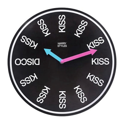Harry Styles KISS wall clock from the Kiss All The Time box set, black face with KISS at every hour except DISCO at 9, pink and light blue hands