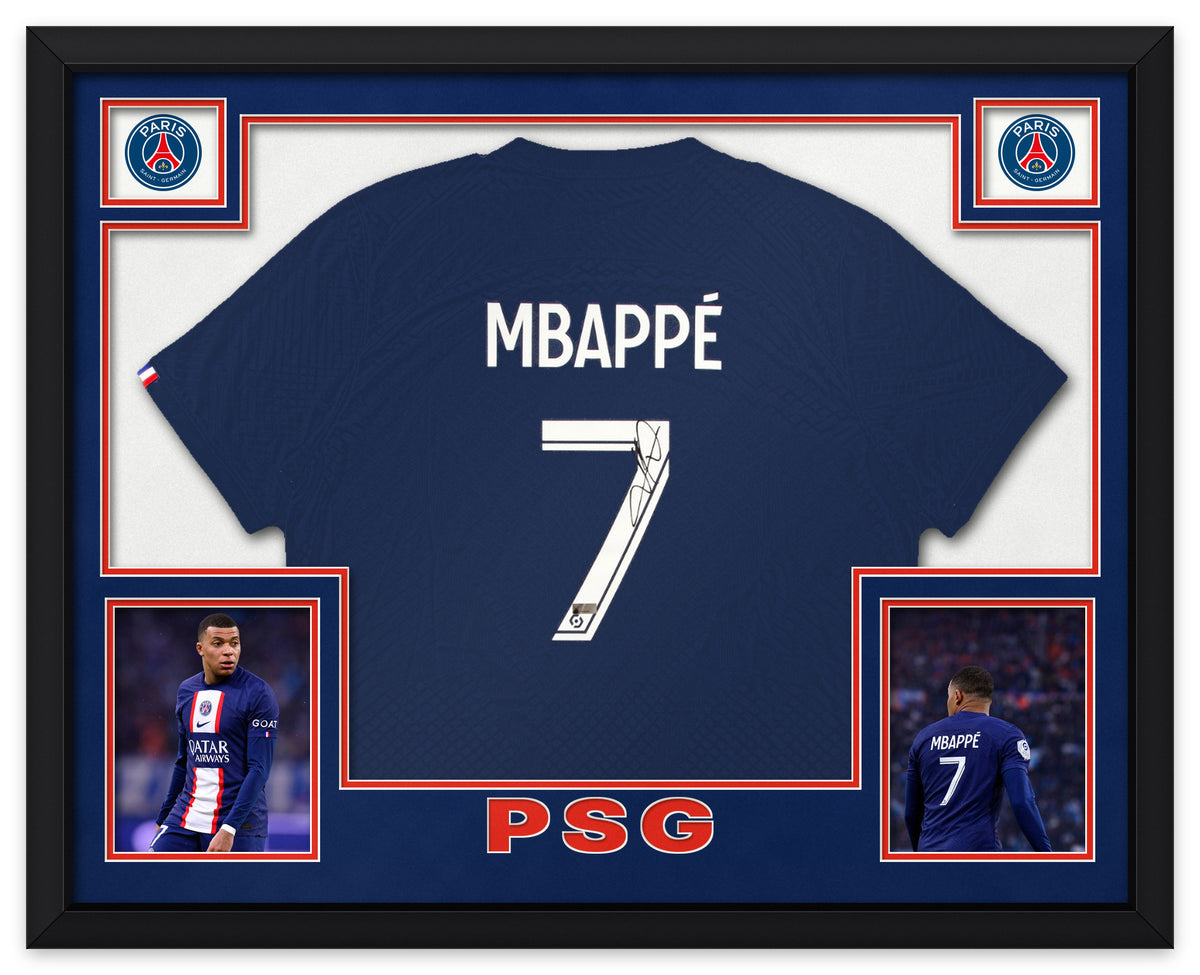 Kylian Mbappé signed navy Paris Saint-Germain 2022-23 home shirt, number 7, signed in black ink with the Panini Authentic hologram, shown in a black custom frame with navy and red matting, PSG crests in the upper corners, two photographs and PSG lettering