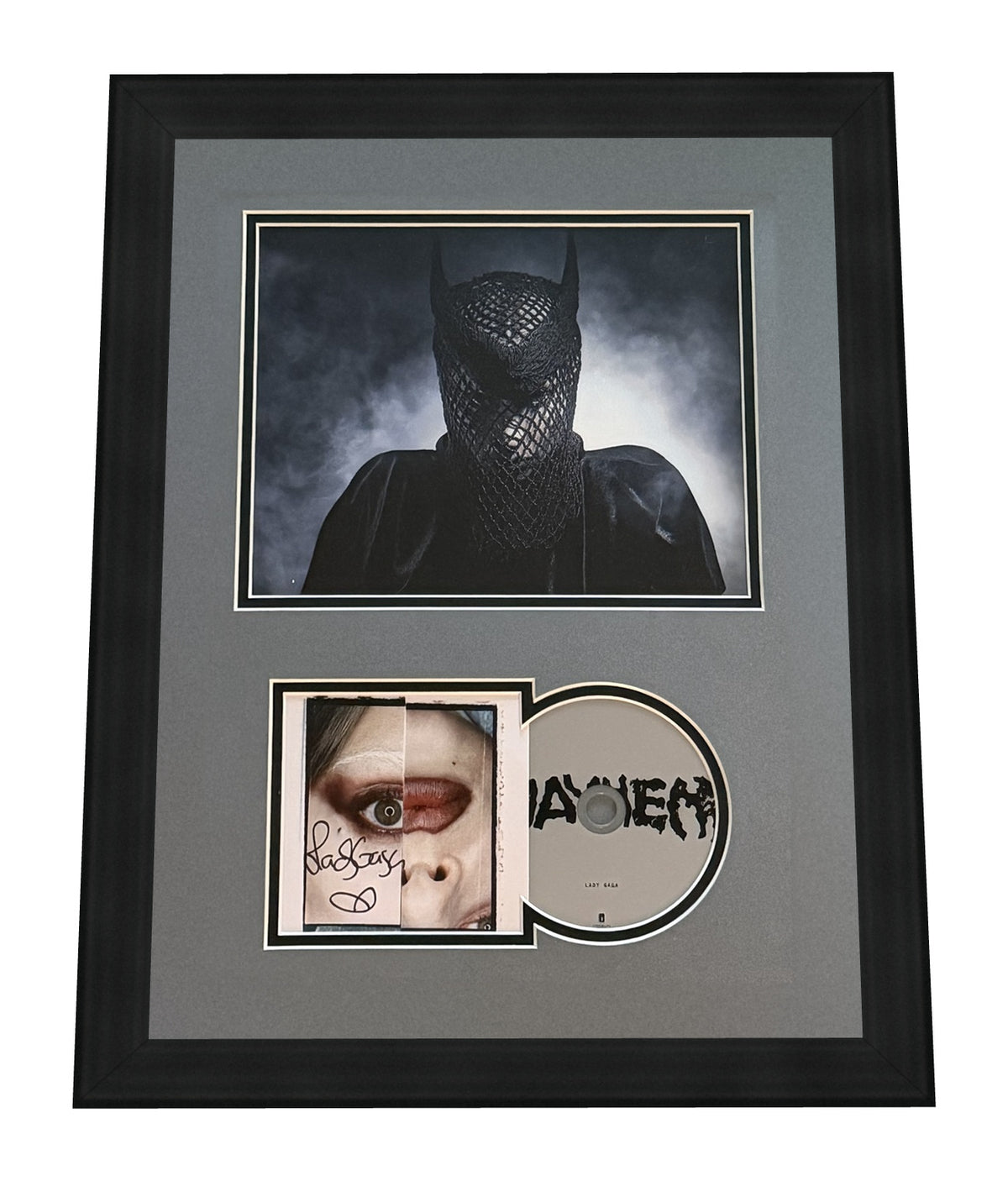 Lady Gaga signed Mayhem framed CD display: a large Mayhem-era print of Gaga veiled in black netting above the CD insert signed in black marker and the gray Mayhem disc, in a gray mat and black frame, ACOA authenticated