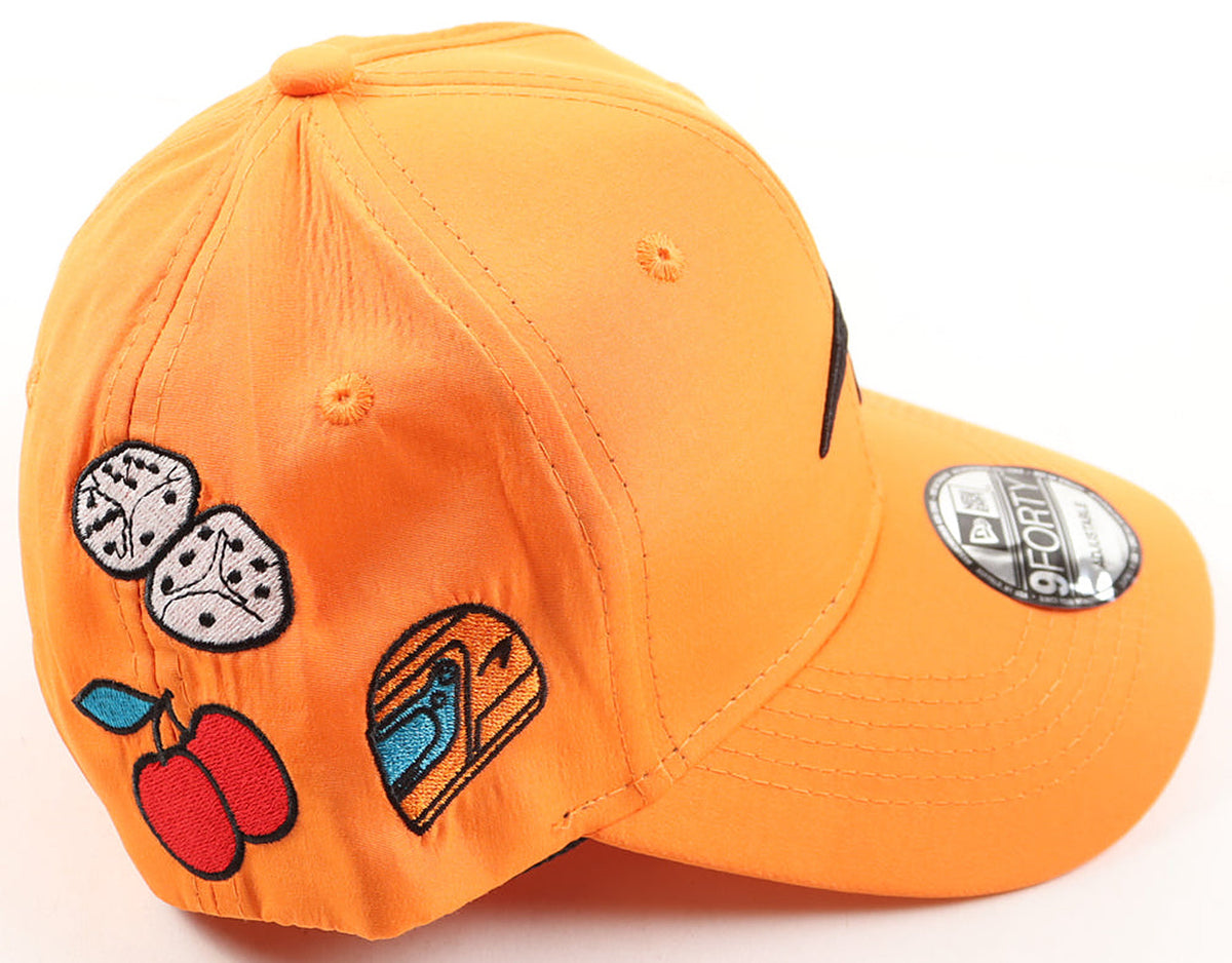 Side of the McLaren F1 Las Vegas Grand Prix New Era hat with dice, cherries and slot machine patches