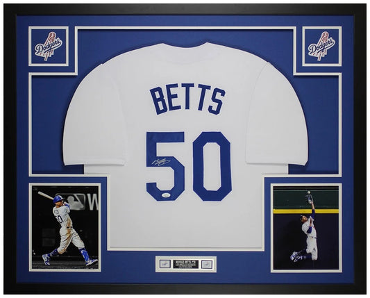Mookie Betts signed Los Angeles Dodgers #50 white home jersey in a custom frame with royal blue mat, two Dodgers logo patches, batting and wall catch photos and an engraved nameplate