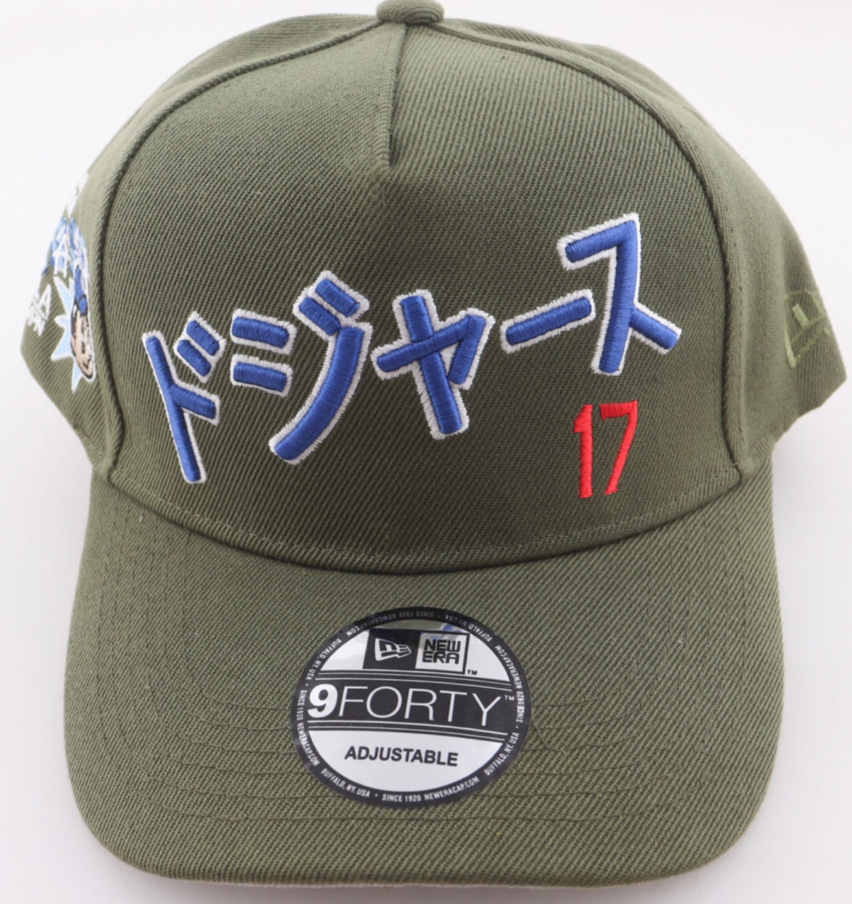Front of the olive green Shohei Ohtani Los Angeles Dodgers New Era 9FORTY Katakana hat with Dodgers in royal blue katakana and number 17 in red
