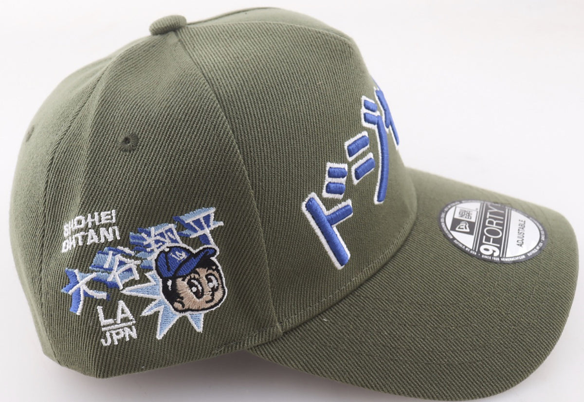 Side of the olive green Shohei Ohtani Dodgers New Era 9FORTY hat showing the Shohei Ohtani patch with his name in kanji and a cartoon character in an LA cap