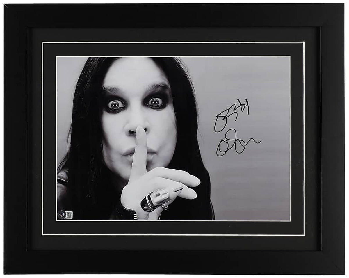Ozzy Osbourne signed 16x20 black and white portrait photo, wide eyed with a finger to his lips, with a Beckett hologram on the photo, in a black frame with black matting