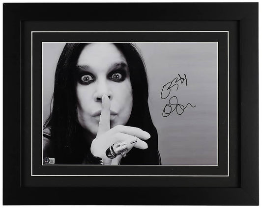 Ozzy Osbourne signed 16x20 black and white portrait photo, wide eyed with a finger to his lips, with a Beckett hologram on the photo, in a black frame with black matting