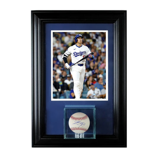 Shohei Ohtani signed baseball in a glass cube, custom framed with a photo of Ohtani in Dodgers home whites, black frame, navy mat