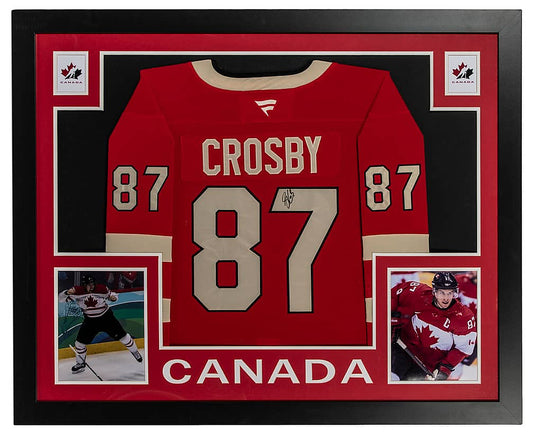 Sidney Crosby signed red Team Canada number 87 jersey in a black frame with red matting, Hockey Canada logos, two photos of Crosby and CANADA lettering