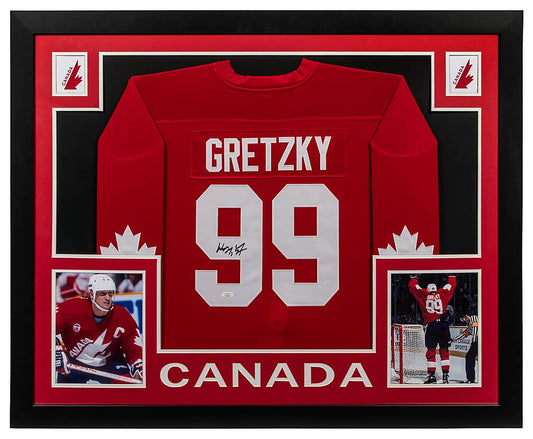 Wayne Gretzky signed red Team Canada number 99 jersey in a black frame with red matting, Team Canada logos, two photos of Gretzky and CANADA lettering